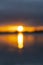 Intense golden sunrise intentionally defocused for abstract or background effect between layer of dark cloudy sky and sea