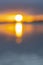 Intense golden sunrise intentionally defocused for abstract or background effect between layer of dark cloudy sky and sea