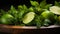 Intense Lighting: Wooden Bowl With Limes And Green Leaves