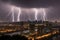 Intense lightning illuminates a cityscape during a stormy night