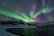 Intense northern lights, Aurora Borealis at a bay near Honningsvag and the Nordkapp, North Cape, Finnmark, Norway