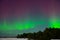 Intense northern lights aurora borealis over beach in Latvia