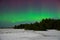 Intense northern lights aurora borealis over beach in Latvia