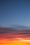 Intense, radiant orange cirrus clouds at dawn against a deep blue sky