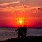 Intense red sunset and fishermen silhouettes