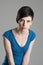 Intense studio portrait of young short hair beauty woman leaning towards and looking at camera