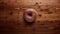 Intensely Detailed Donut On Brown Wood Background