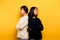 intensity of communication misunderstanding Two friends don\'t talk to each other after a fight. behind the yellow background