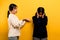 intensity of communication misunderstanding Two friends don\\\'t talk to each other after a fight. behind the yellow background