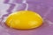 Intensive yellow egg yolk on purple background