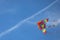 intentional blur of a big  kite with the colors of the rainbow flying moving in the sky