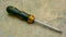 Interchangeable to torx plus head and flat head screwdriver with yellow handle on the floor