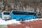 Intercity buses parked near the mountain forest at winter