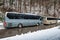 Intercity buses parked near the mountain forest at winter