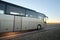 Intercity passenger bus driving on highway in evening