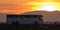 Intercity passenger bus driving on highway road in evening