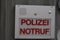 Intercom call box with inscription in German saying police emergency