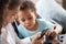 Interested African American children using smartphone together