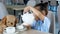 Interested Asian toddler girl pours tea into white cups