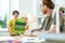 Interested dark-haired little boy in clear glasses presenting poster