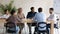 Interested diverse employees listening to mentor at meeting in boardroom