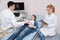 Interested gynecologists providing examination for pregnant woman at work