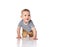 Interested infant child boy in t-shirt and green pants is crawling on all fours, looking at free copy space on white