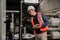 Interested male engineer holding tablet examining steel frames in factory.