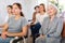 Interested senior woman listening to lecture with group of women