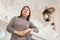 Interested woman standing near stucco railings on stairs in antique palace