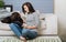 Interested young woman reading a book with her pet