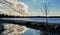 Interesting Cloud by Lake with Reflection in Puddle