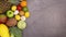 Interesting composition of fresh ripe fruits and vegetables move on left side of dark background. Stop motion