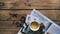 Interesting composition of the lovely postcard, book of paintings, cup of tea and magnifying glass decorated with herbs