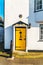 Interesting entrance to the building, yellow door with bull`s ey