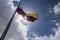 Interesting photograph of the flag of Venezuela waving in low angle with a sunny and cloudy sky