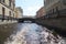 An interesting place in the city of St. Petersburg in Russia, the passage of low walking tourist steamers under bridges in a city