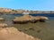 Interesting rock formations protrude from the seabed at a beach at Sharm El Sheik, Egypt