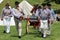 Interesting scene with many men dressed as soldiers demonstrating weapons, seen at war reenactment, Fort Ontario, Oswego NY, 2016