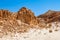 Interesting shapes trails surrounded by caves, rocks, cliffs of ancient cooper mines canyons and mountains range in Timna National