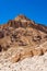 Interesting shapes trails surrounded by caves, rocks, cliffs of ancient cooper mines canyons and mountains range in Timna National