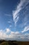 Interesting shapes of white clouds above sea wall