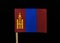A interesting and unique flag of Mongolia on woodpick on black background. A vertical triband of red and blue with the Soyombo