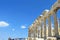 An interesting view of the Parthenon columns facing a blue sky atop the Acropolis in Greece.