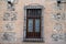 Interesting window and  wall brick facade with bars on window in Madrid Spain