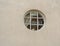Interestingly round window in the wall of the building, the wind