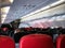 Interior of Air asia airplane with passengers sitting on seats