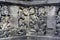 Interior of ancient Borobudur temple lower terraces. Close up of detail a stone relief on the wall.