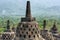 Interior of ancient Borobudur Temple. View of stupas on upper terrace overlooking a mountain.