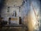 The interior of an ancient, small and forgotten church. Lunigiana, Italy. With statue and crucifix.